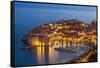 Aerial view of Old Port and Dubrovnik Old Town at night, UNESCO World Heritage Site, Dubrovnik, Dal-Neale Clark-Framed Stretched Canvas