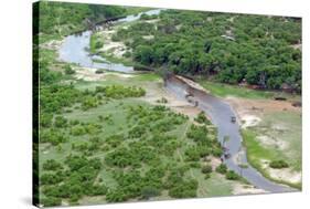Aerial view of river, African Elephants (Loxodonta africana) and tourist lodge, Botswana-Jean Hosking-Stretched Canvas