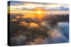 Aerial view of sun rays at sunset lighting up the clouds over Romsdalen valley-Roberto Moiola-Stretched Canvas