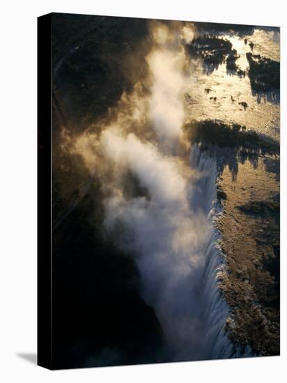 Aerial View of Zambezi River as it Plummets over the Victoria Falls-John Warburton-lee-Stretched Canvas