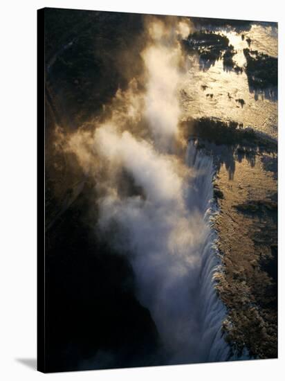 Aerial View of Zambezi River as it Plummets over the Victoria Falls-John Warburton-lee-Stretched Canvas