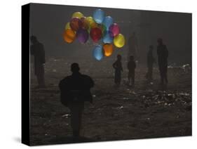 Afghan Boy Runs with Balloons to Join His Friends in Dusty Alley in Kabul, Afghanistan-null-Stretched Canvas