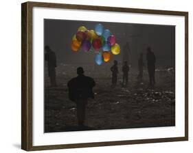 Afghan Boy Runs with Balloons to Join His Friends in Dusty Alley in Kabul, Afghanistan-null-Framed Photographic Print