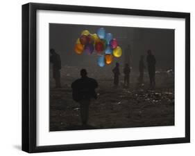 Afghan Boy Runs with Balloons to Join His Friends in Dusty Alley in Kabul, Afghanistan-null-Framed Photographic Print