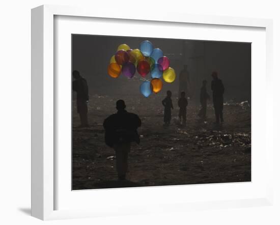 Afghan Boy Runs with Balloons to Join His Friends in Dusty Alley in Kabul, Afghanistan-null-Framed Photographic Print