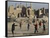 Afghan Boys Play Soccer Near a Mosque and Ruined Buildings During the Early Morning-null-Framed Stretched Canvas