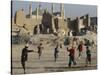 Afghan Boys Play Soccer Near a Mosque and Ruined Buildings During the Early Morning-null-Stretched Canvas