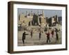 Afghan Boys Play Soccer Near a Mosque and Ruined Buildings During the Early Morning-null-Framed Premium Photographic Print