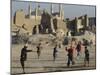 Afghan Boys Play Soccer Near a Mosque and Ruined Buildings During the Early Morning-null-Mounted Premium Photographic Print