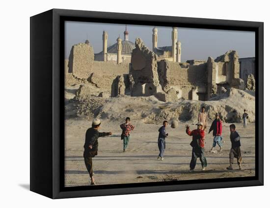 Afghan Boys Play Soccer Near a Mosque and Ruined Buildings During the Early Morning-null-Framed Stretched Canvas