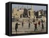 Afghan Boys Play Soccer Near a Mosque and Ruined Buildings During the Early Morning-null-Framed Stretched Canvas