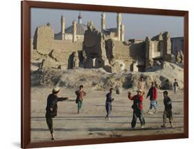 Afghan Boys Play Soccer Near a Mosque and Ruined Buildings During the Early Morning-null-Framed Photographic Print