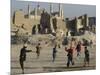 Afghan Boys Play Soccer Near a Mosque and Ruined Buildings During the Early Morning-null-Mounted Photographic Print