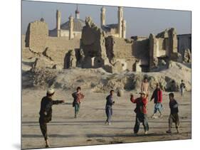 Afghan Boys Play Soccer Near a Mosque and Ruined Buildings During the Early Morning-null-Mounted Photographic Print