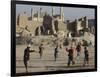 Afghan Boys Play Soccer Near a Mosque and Ruined Buildings During the Early Morning-null-Framed Photographic Print