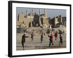 Afghan Boys Play Soccer Near a Mosque and Ruined Buildings During the Early Morning-null-Framed Photographic Print