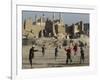 Afghan Boys Play Soccer Near a Mosque and Ruined Buildings During the Early Morning-null-Framed Photographic Print