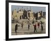 Afghan Boys Play Soccer Near a Mosque and Ruined Buildings During the Early Morning-null-Framed Photographic Print