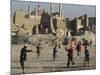 Afghan Boys Play Soccer Near a Mosque and Ruined Buildings During the Early Morning-null-Mounted Photographic Print