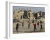 Afghan Boys Play Soccer Near a Mosque and Ruined Buildings During the Early Morning-null-Framed Photographic Print