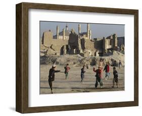 Afghan Boys Play Soccer Near a Mosque and Ruined Buildings During the Early Morning-null-Framed Photographic Print