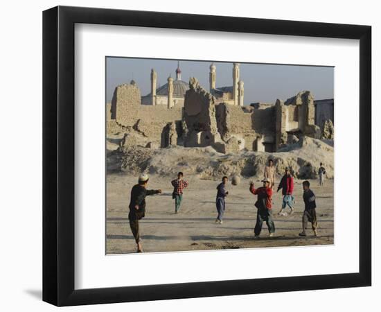 Afghan Boys Play Soccer Near a Mosque and Ruined Buildings During the Early Morning-null-Framed Photographic Print
