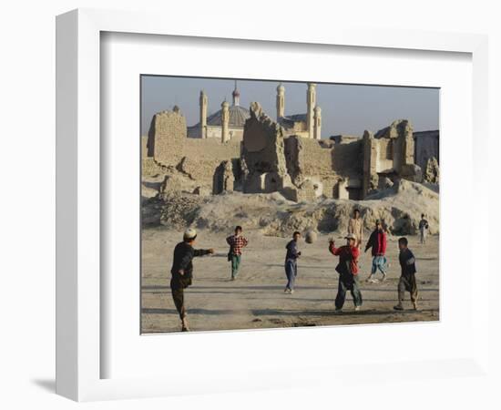 Afghan Boys Play Soccer Near a Mosque and Ruined Buildings During the Early Morning-null-Framed Photographic Print