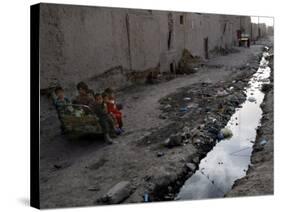 Afghan Children Sit Together Aboard an Old Cart-null-Stretched Canvas