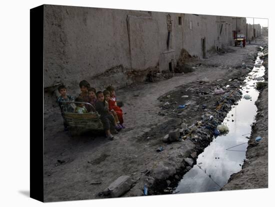 Afghan Children Sit Together Aboard an Old Cart-null-Stretched Canvas