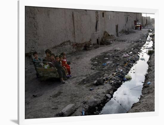 Afghan Children Sit Together Aboard an Old Cart-null-Framed Photographic Print