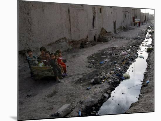 Afghan Children Sit Together Aboard an Old Cart-null-Mounted Photographic Print