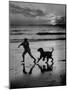 Afghan Dog Roaming across Beach with Girl at Sundown, During Preparation for Westminister Show-George Silk-Mounted Premium Photographic Print