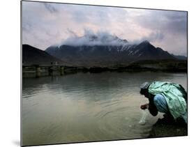 Afghan Man Washes His Face in the River before Going to Evening Prayers-null-Mounted Photographic Print