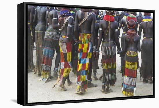 Africa, Ethiopia, Southern Omo Valley. Nyangatom women wear long leather skirts with beadwork.-Ellen Goff-Framed Stretched Canvas