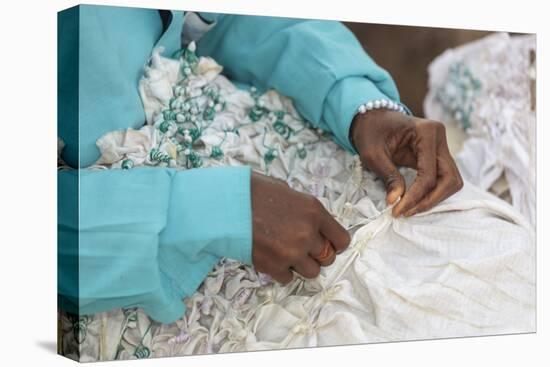 Africa, Gambia, Banjul. Close-up of Woman tying fabric for dyeing.-Alida Latham-Stretched Canvas