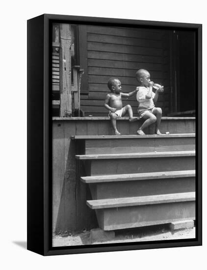 African American Boys at top of Stairs as Older Boy is Drinking Soda and Younger One Reaches for It-Alfred Eisenstaedt-Framed Stretched Canvas