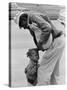 African American Man Comforts Crying Child Photograph-Lantern Press-Stretched Canvas