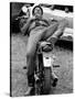 African American Man Relaxing on His Motocycle During Motorcycle Races near Detroit, Michigan-John Shearer-Stretched Canvas