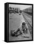 Aged Refugee Fighting Hunger, Sweeps Up Spilled Rice on the Railroad Station Platform-Jack Birns-Framed Stretched Canvas