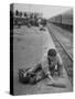 Aged Refugee Fighting Hunger, Sweeps Up Spilled Rice on the Railroad Station Platform-Jack Birns-Stretched Canvas
