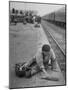 Aged Refugee Fighting Hunger, Sweeps Up Spilled Rice on the Railroad Station Platform-Jack Birns-Mounted Photographic Print