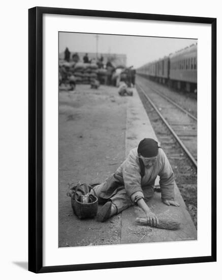 Aged Refugee Fighting Hunger, Sweeps Up Spilled Rice on the Railroad Station Platform-Jack Birns-Framed Photographic Print