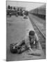 Aged Refugee Fighting Hunger, Sweeps Up Spilled Rice on the Railroad Station Platform-Jack Birns-Mounted Photographic Print