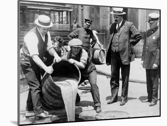 Agents pour liquor into sewer following a raid during the height of prohibition, New York, 1921-null-Mounted Photographic Print