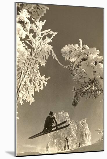 Airborne Skier Amid Frost-Laden Trees-null-Mounted Art Print