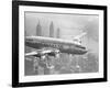 Aircraft Flying over City-null-Framed Photographic Print