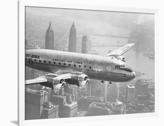 Aircraft Flying over City-null-Framed Photographic Print