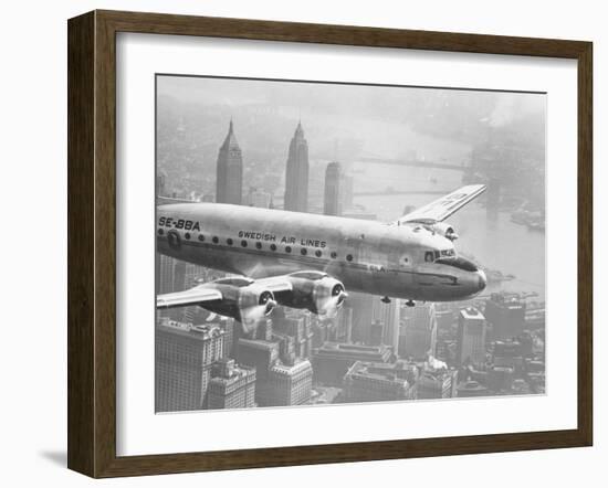 Aircraft Flying over City-null-Framed Photographic Print
