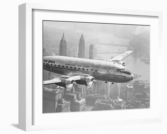 Aircraft Flying over City-null-Framed Photographic Print