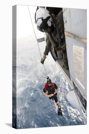 Aircrewman Assists in Hoisting a Member into an Mh-60S Sea Hawk-null-Stretched Canvas